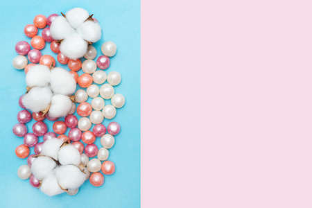 Round candies in glaze and cotton flowers. Candy pearls. White, orange and purple. Pink and blue...