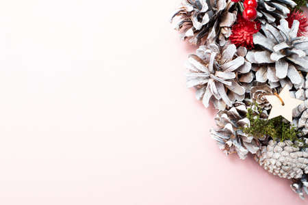 New Years wreath. Bumps on a pink background. Pastel colors. Copy space. Place for text. Layout for design. Flay lay. Top view. New Year invitation. Concept.の写真素材