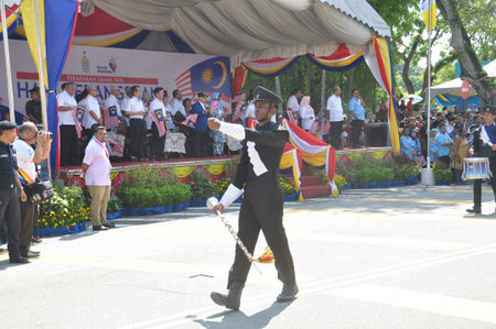 GEORGE TOWN, MALAYSIA - AUGUST 31, 2016 : Student waving Malaysia flag also known as Jalur Gemilang on Independence Day celebration or Merdeka Day.のeditorial素材