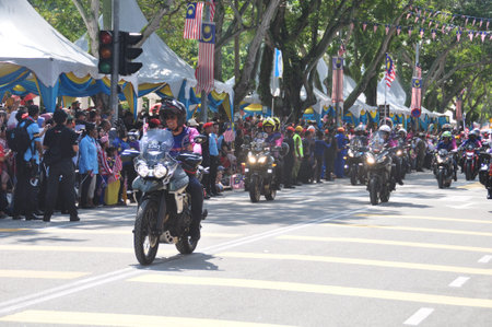 GEORGE TOWN, MALAYSIA - AUGUST 31, 2016 : Student waving Malaysia flag also known as Jalur Gemilang on Independence Day celebration or Merdeka Day.のeditorial素材