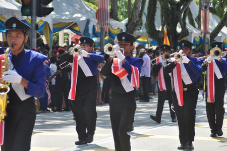 GEORGE TOWN, MALAYSIA - AUGUST 31, 2016 : Student waving Malaysia flag also known as Jalur Gemilang on Independence Day celebration or Merdeka Day.のeditorial素材
