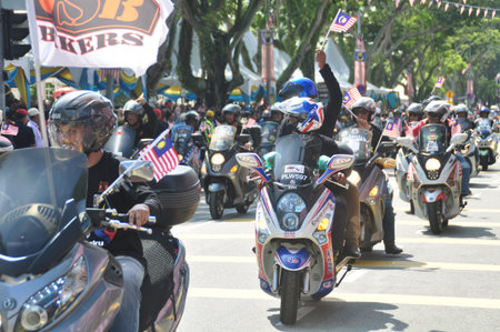 GEORGE TOWN, MALAYSIA - AUGUST 31, 2016 : Student waving Malaysia flag also known as Jalur Gemilang on Independence Day celebration or Merdeka Day.のeditorial素材