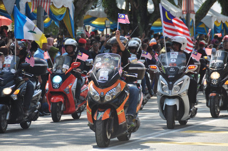 GEORGE TOWN, MALAYSIA - AUGUST 31, 2016 : Student waving Malaysia flag also known as Jalur Gemilang on Independence Day celebration or Merdeka Day.のeditorial素材