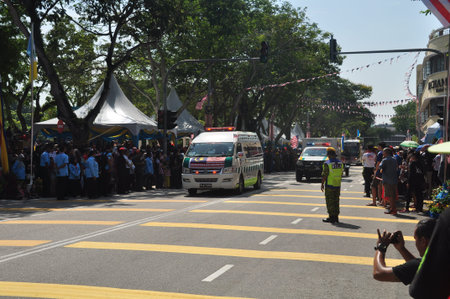 GEORGE TOWN, MALAYSIA - AUGUST 31, 2016 : Student waving Malaysia flag also known as Jalur Gemilang on Independence Day celebration or Merdeka Day.のeditorial素材