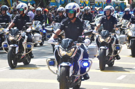 GEORGE TOWN, MALAYSIA - AUGUST 31, 2016 : Student waving Malaysia flag also known as Jalur Gemilang on Independence Day celebration or Merdeka Day.のeditorial素材