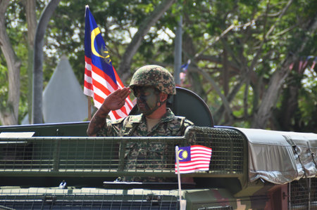 GEORGE TOWN, MALAYSIA - AUGUST 31, 2016 : Student waving Malaysia flag also known as Jalur Gemilang on Independence Day celebration or Merdeka Day.のeditorial素材