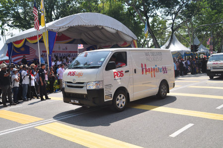 GEORGE TOWN, MALAYSIA - AUGUST 31, 2016 : Student waving Malaysia flag also known as Jalur Gemilang on Independence Day celebration or Merdeka Day.のeditorial素材