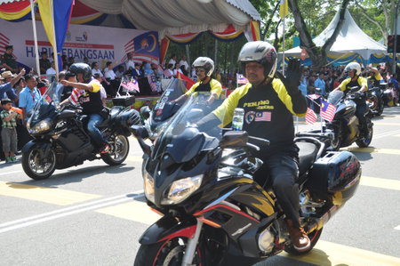 GEORGE TOWN, MALAYSIA - AUGUST 31, 2016 : Student waving Malaysia flag also known as Jalur Gemilang on Independence Day celebration or Merdeka Day.のeditorial素材