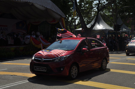 GEORGE TOWN, MALAYSIA - AUGUST 31, 2016 : Student waving Malaysia flag also known as Jalur Gemilang on Independence Day celebration or Merdeka Day.のeditorial素材