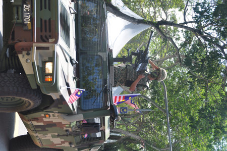 GEORGE TOWN, MALAYSIA - AUGUST 31, 2016 : Student waving Malaysia flag also known as Jalur Gemilang on Independence Day celebration or Merdeka Day.のeditorial素材