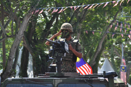 GEORGE TOWN, MALAYSIA - AUGUST 31, 2016 : Student waving Malaysia flag also known as Jalur Gemilang on Independence Day celebration or Merdeka Day.のeditorial素材