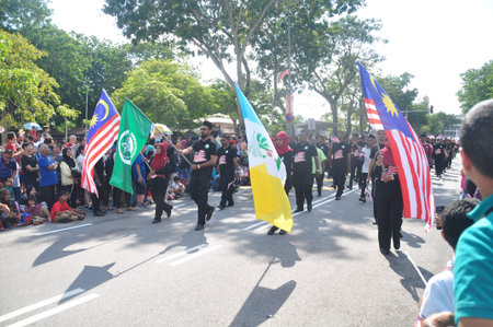 GEORGE TOWN, MALAYSIA - AUGUST 31, 2016 : Student waving Malaysia flag also known as Jalur Gemilang...