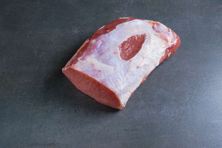 Pork chop on a gray background. Raw meat.の写真素材