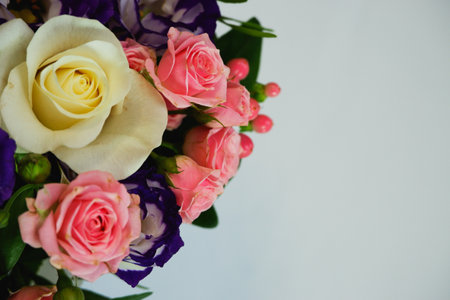 Background. Bouquet of flowers close-up on a white background. White and pink roses, blue-white eustoma. Place for text.の写真素材