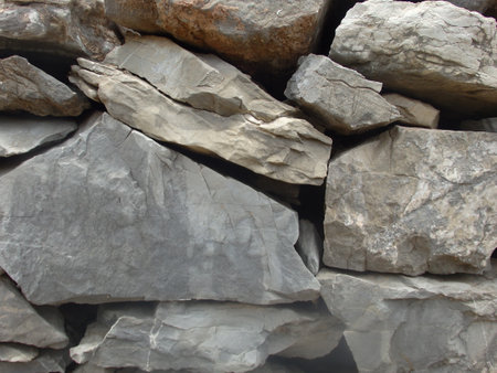 Background from rock texture close-up. The wall of natural stone of gray and brown.の写真素材