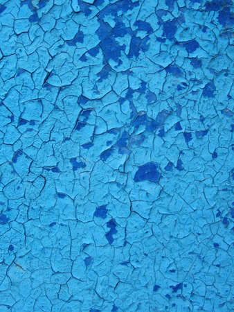 Aged painted cracked boards with blue color peeling paint. Old natural grunge textured wooden texture. Weathered woodの写真素材