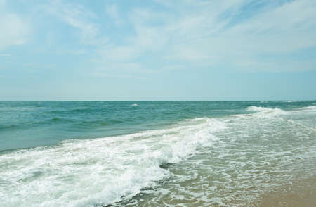 The sea is meeting the sand on the beachの写真素材