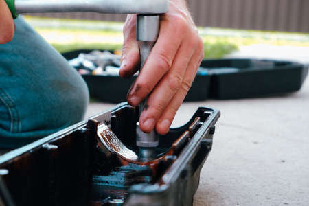 Car repair. Internal combustion engine repair. Resin deposits from low-quality oil on the valve cover. Flushing the oil filter.の写真素材