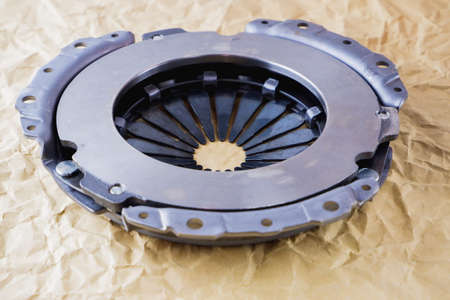 Passenger car clutch basket. Photo of a new clutch on a background of craft paper.