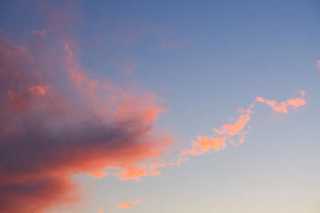 Dramatic sunset. Red-orange clouds against the blue sky. Sunset orange red yellow pink clouds...