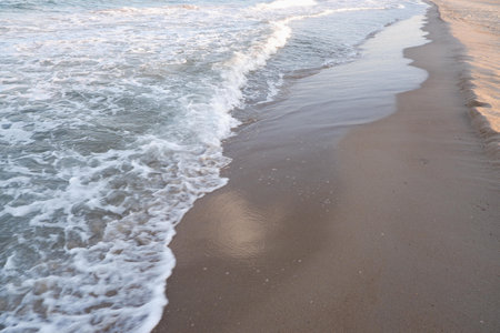 Clear sea water, wave and sand beach. Text space.
