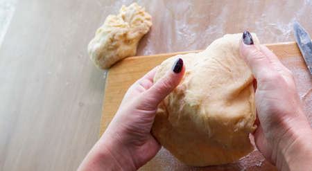 Homemade bread baking. Closeup woman hands kneading The Dough. Beautiful, cook.