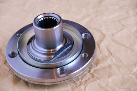 Auto parts. Car hub close-up on craft paper