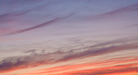 Scenery. Photo of the evening sky. Crimson yellow clouds against a blue sky at sunset before a thunderstorm.の写真素材