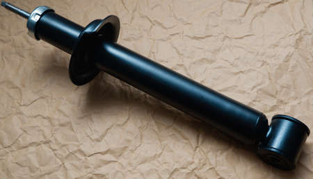 New car shock absorber on a background of crumpled kraft paper.の写真素材