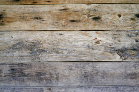 The surface of an old wooden slab house. Old slab texture. Close up brown Wooden planks texture backgroundsの写真素材