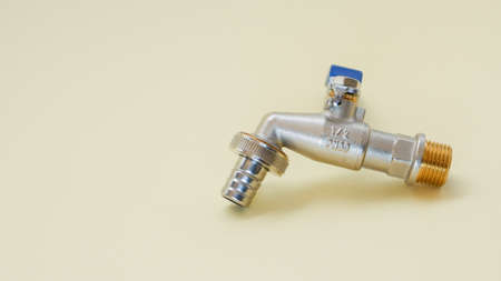 Watering tap on a light background close-up. Plumbing fittings.