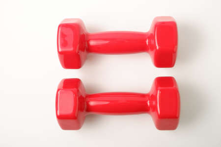 Sport equipment. Two red dumbbells weighing 2 kg on a white background.の写真素材
