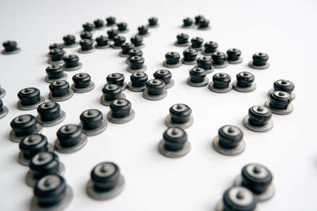 Repair of winter studded tires. Repaired spikes scattered on a white background. Replaced lost tire...