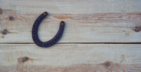 Old rusty horseshoe on a pine board. natural wood background. Place for text.の写真素材