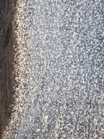 Snow ice texture. Thawed frost on a wooden board. wooden planks with melting snow.