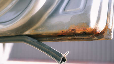 Car door with rust and metal corrosion. lose up corrosion, old rusty stain on hood car. Hard...