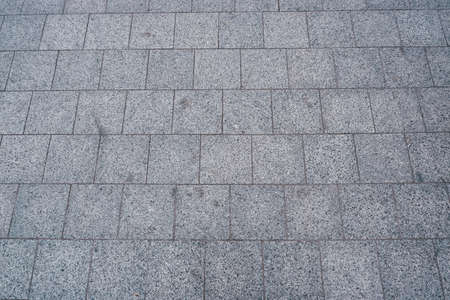 Modern city road paved with granite gray stone. texture stone pavement in the city. Modern...