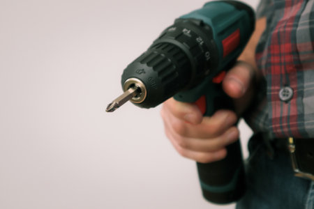 Handworker working with an electric screwdriver. A man using the drill in the homeの写真素材