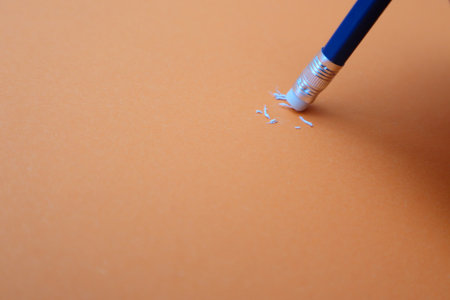 Eraser erasing. Close up a eraser pencil Mistake and Unsuccessful concept, Eraser pencil with orange paperの写真素材