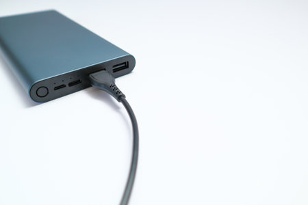 Power bank mockup isolated on white background. Gray metallic USB power bank for smartphones and...