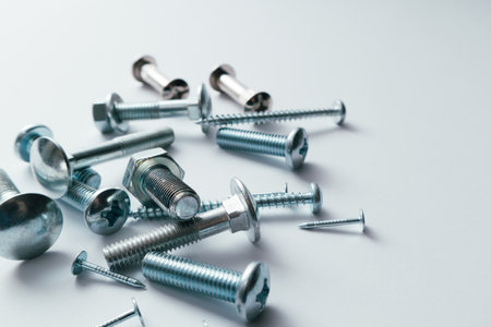 Set of bolts, screws, nails. construction abstraction. industrial background. Screws and bolts macro photo, white background, steel screw, bolt macro.の写真素材