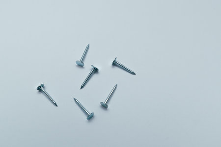 Set of metal nail heads isolated on white background. Metallic nail for joining wooden detail.の写真素材