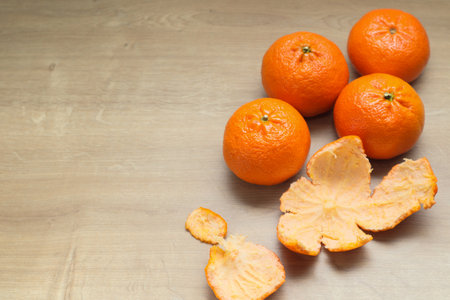 Fresh mandarin oranges fruit or tangerines on a wooden tableの写真素材