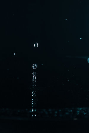 Splash water. Water drop splash close up on black background.の写真素材