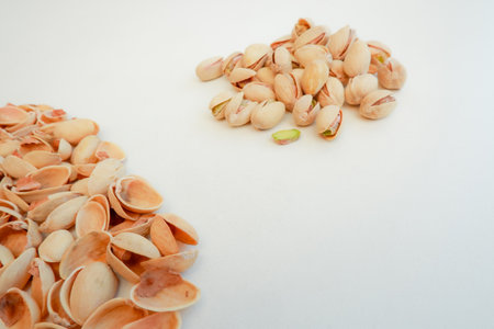 A pile of Pistachio nuts and nutshell on a white background. Pistachios background, place for text.の写真素材