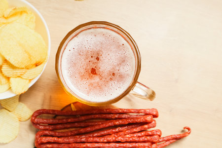 Plate with beer snacks, potato chips, meat sausages. Pork or beef sausage with beer.の写真素材