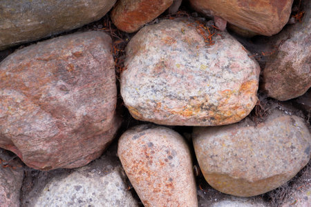 Retaining wall made of large large natural stones. Stacked stones at the base of the building. Close-up texture of big old rock wall for backgroundの写真素材
