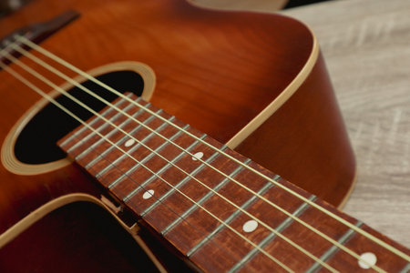 Close up of a acoustic guitar string and fingerboard with new strings. Photo of an old wooden guitar...