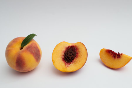 Fresh ripe whole, half and sliced peach isolated on white background. Healthy lifestyle, vitamin, diet concept.の写真素材