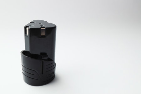 Rechargeable battery for electric cordless screwdriver on a white background. Selective focus, copy spaceの写真素材